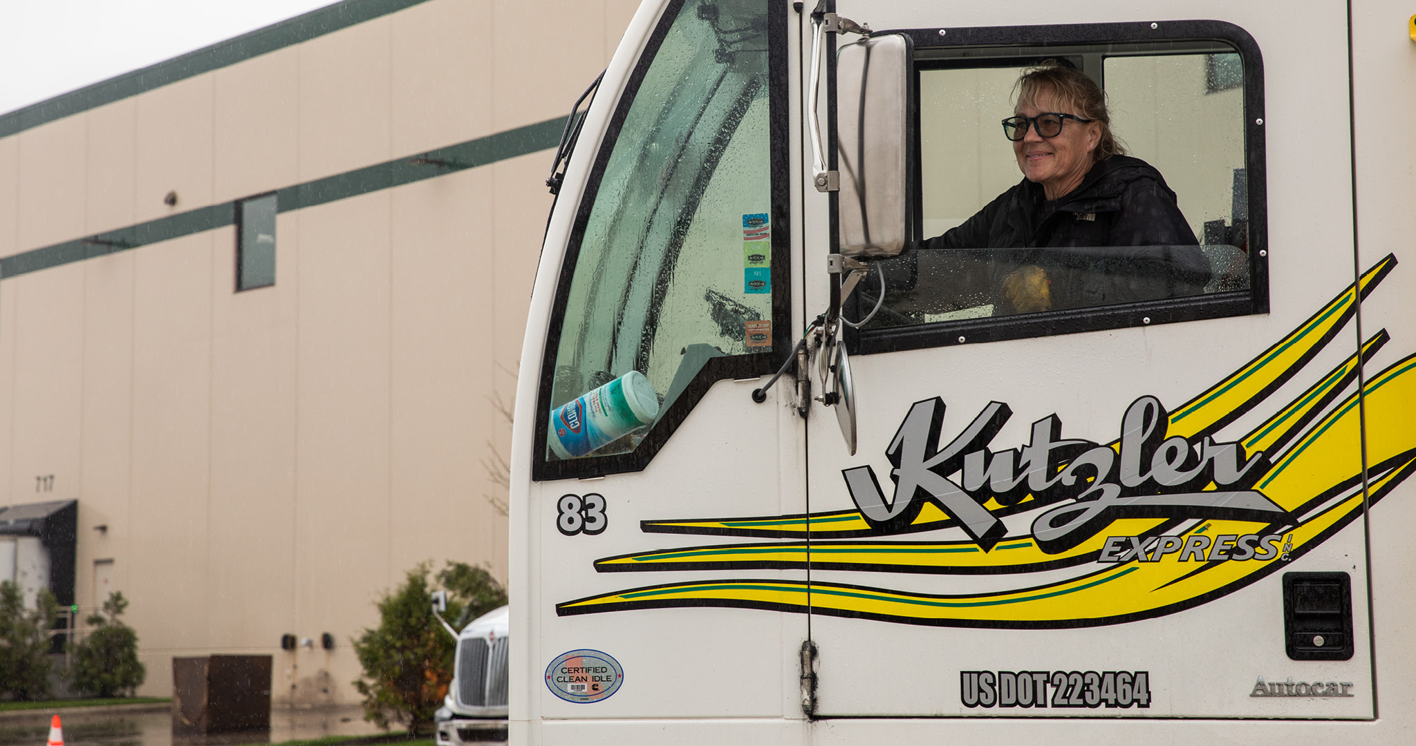 A Kutzler Express driver in a branded white truck