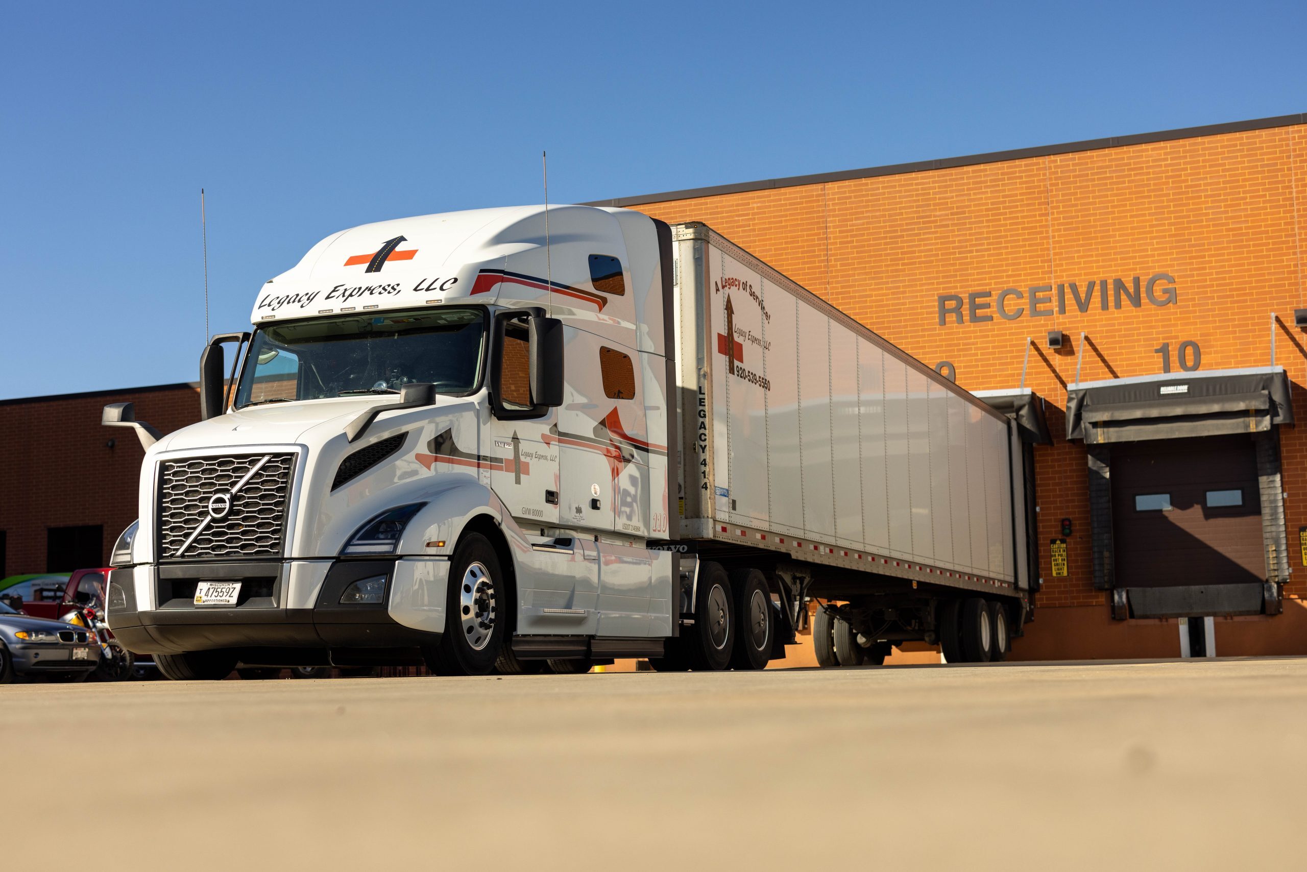A branded white Volvo truck parked in a loading bay