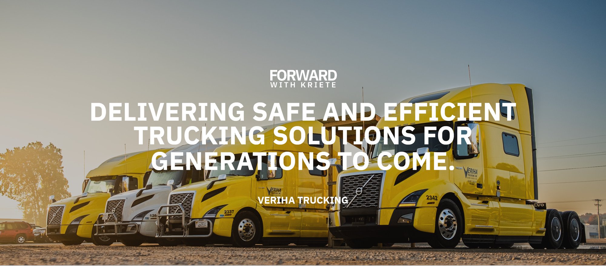 A row of yellow and white, Veriha-branded Volvo trucks