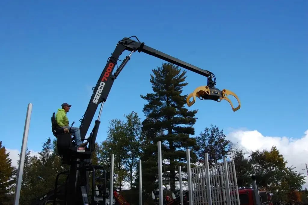 The Serco 7000 knuckleboom loader in action