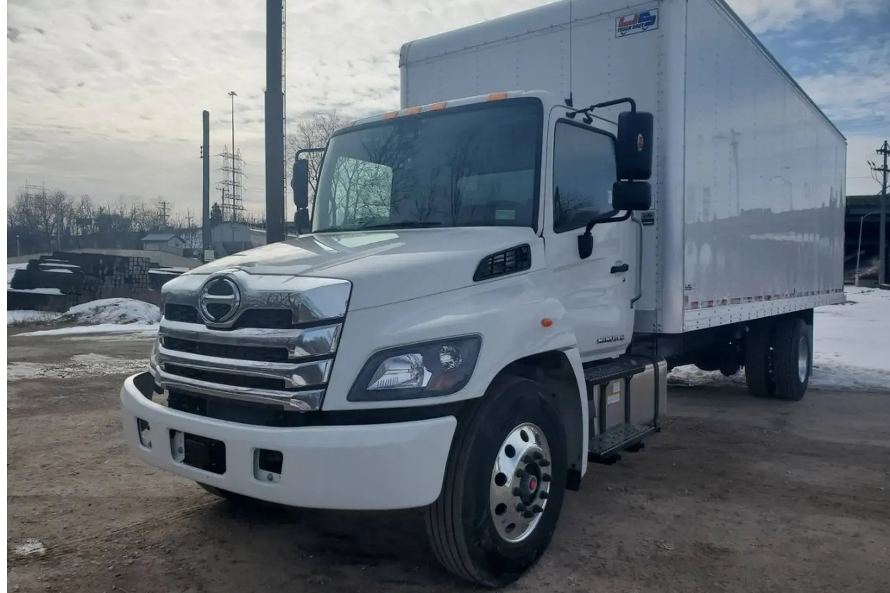 White Hino L6 truck in a snowy car park
