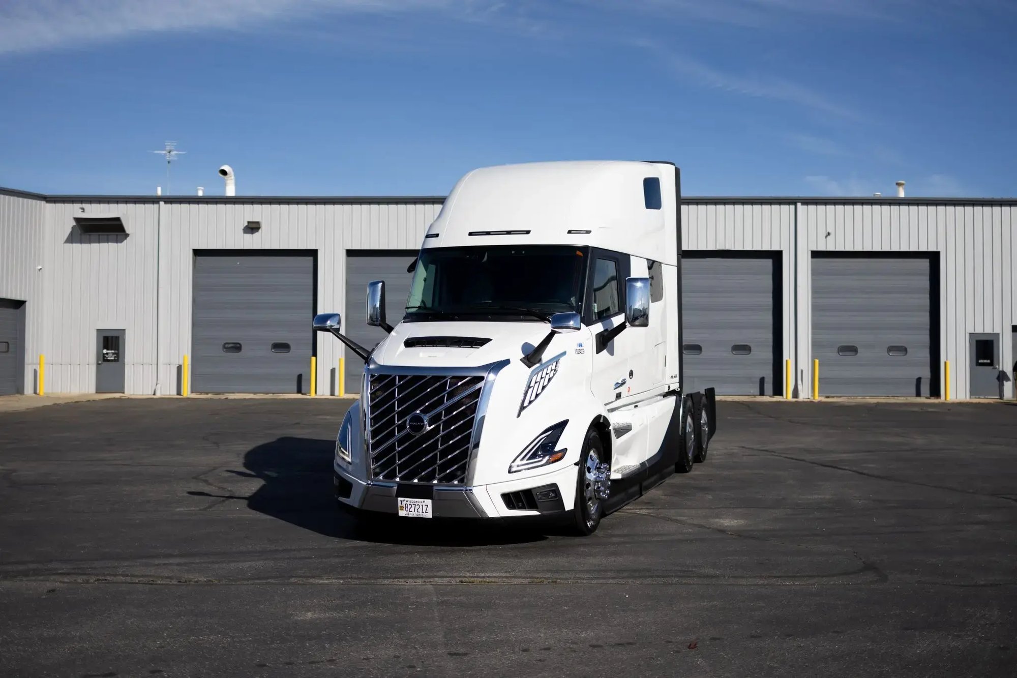 White Volvo VNL parked outside a Kriete facility