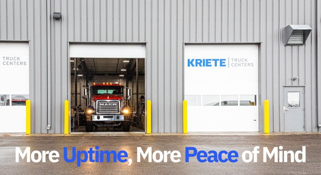 A red Mack truck emerging from a Kriete warehouse