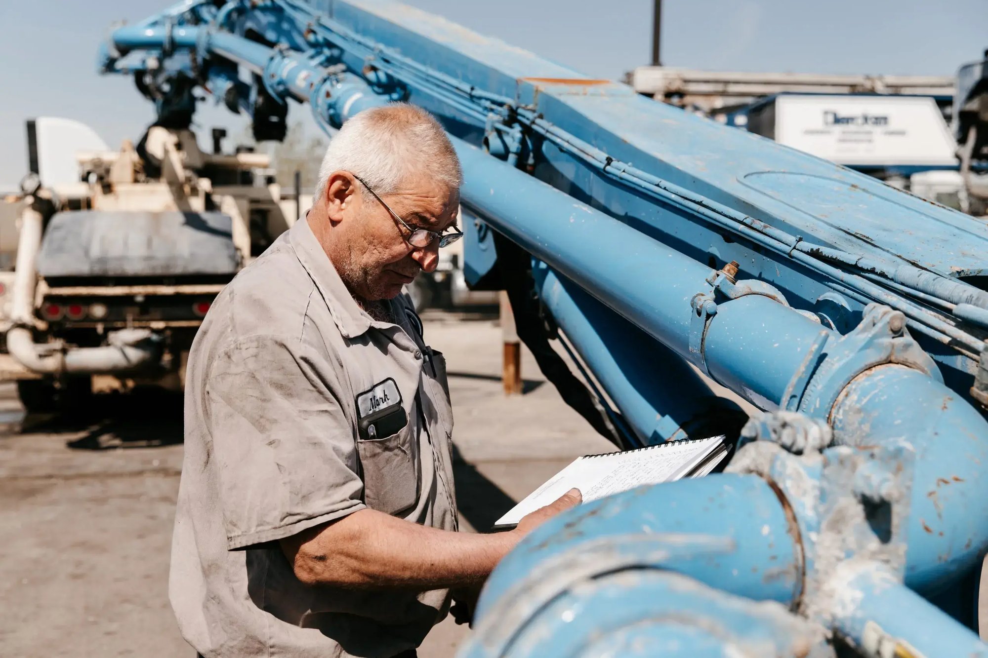 Mark Kelemen reviewing information on a paper pad in front of a boom