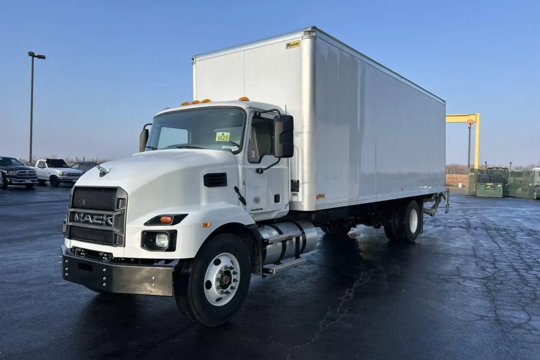 White Mack MD truck with an attached shipping container