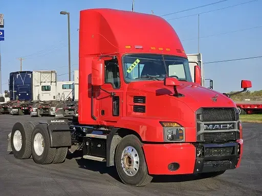 Red Mack truck with a 'sale' sign on the windscreen