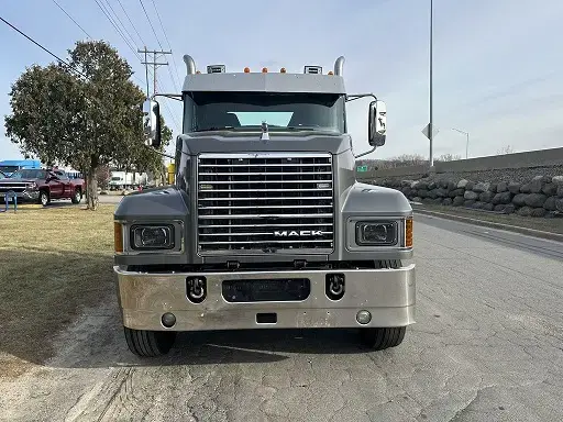 Dark gray Mack truck seen front-on