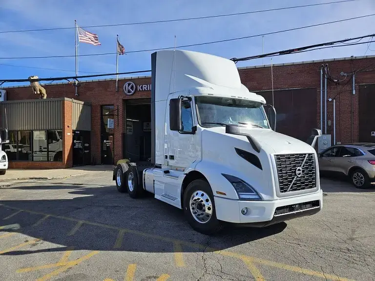 Pristine white Volvo VNR parked outside a Kriete facility
