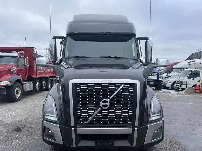 Black Volvo VNL truck, front-on view