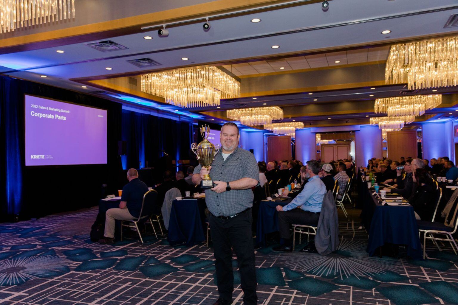 Kent Fassbender, Service Manager - Milwaukee, poses with a trophy. Kriete Truck Center - Milwaukee was selected as Kriete's 2022 Service Department of the Year.