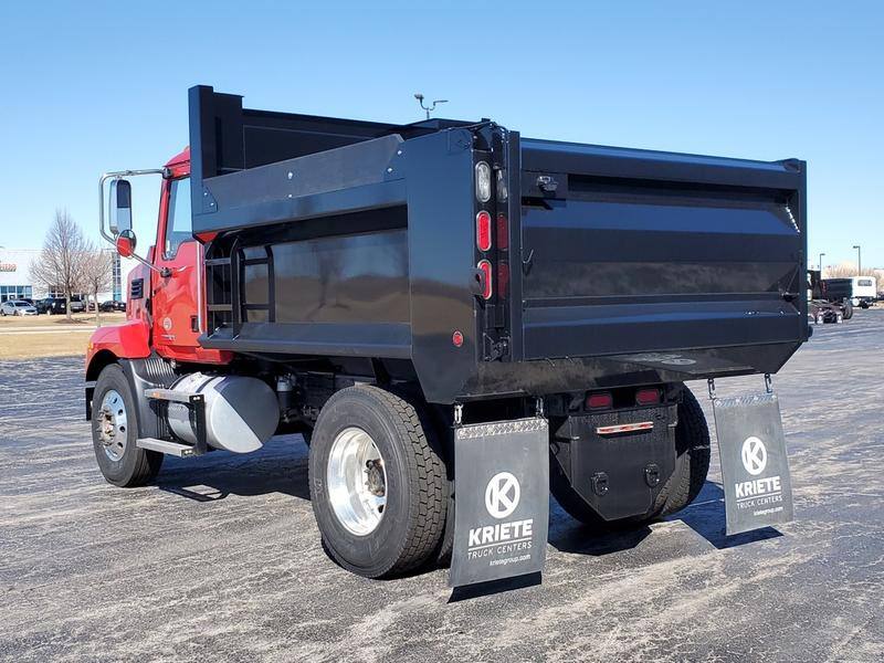 A black Cross Country CCMD dump body with straight gate, mounted on a red truck